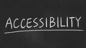 "The word 'Accessibility' written in white chalk on a blackboard, underlined.
